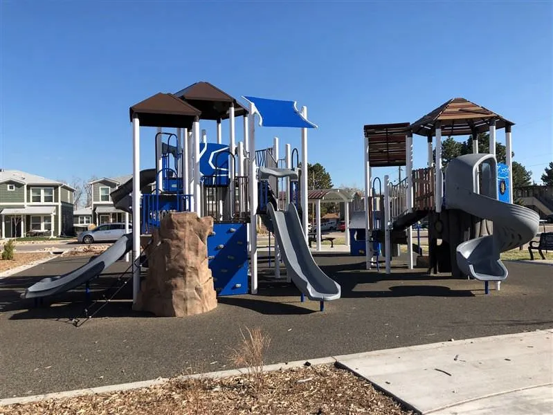 Small, medium and winding slides with small rock wall at Sheridan Square Park